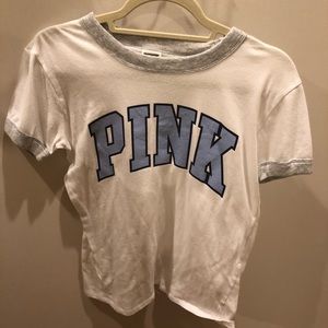 This pink brand shirt with a light blue logo